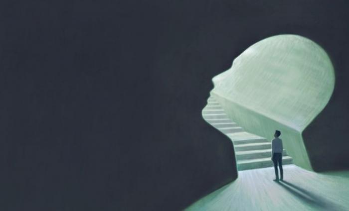 Illustration of a man standing at the bottom of some steps with a shadow of a person's face at the bottom.