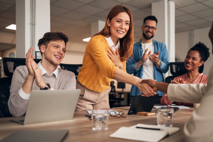 Star performer being congratulated at work